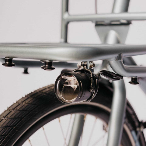 Detailansicht der Frontbeleuchtung am Compact Cargobike Flinc. Robuste Konstruktion für sichere Fahrten bei Nacht.