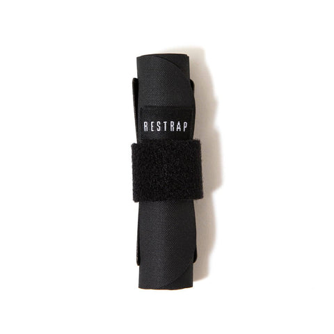 a roll of black fabric with a white restrap logo on it